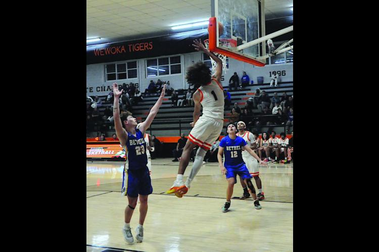 Wewoka Tiger Nadim Bruner flies in for the layup Thursday night. Staff Photo by Bill Anderson