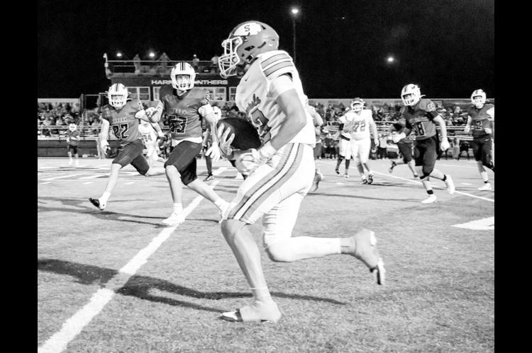 Seminole’s Tre Johnson looks for open space Friday night against Harrah. (Photo by Ben Schatzel)