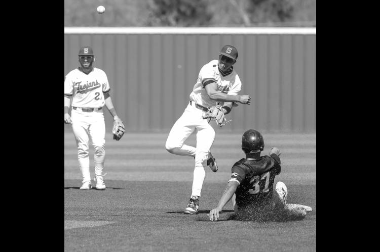 Seminole State Trojan Cohl McCoy makes a throw to first base in a double play. Courtesy Photo by Glen Bryan