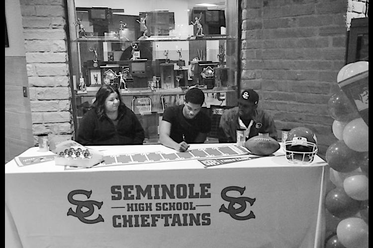 Garfield Signs to Pitt Staff Photo by Bill Anderson Seminole Chieftain Dontre Garfield signs Letter of Intent with the University of Pittsburg Wednesday afternoon. Pictured is Dontre and family.