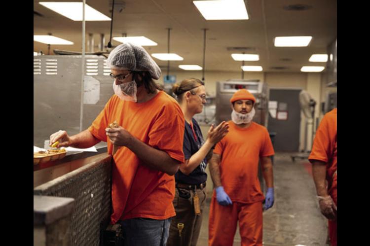 Prisoners are shown working in the kitchen at the Joseph Harp Correctional Center in Lexington. (Brent Fuchs/Oklahoma Watch)