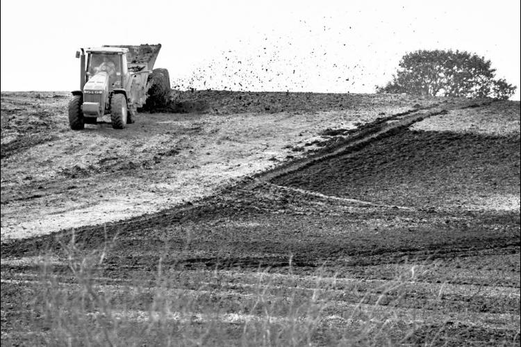 A spreader applies sewage sludge to a farm field, Monday, Feb. 17, 2025, in Wellston, Okla. (AP Photo/Joshua A. Bickel)