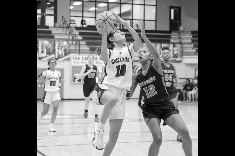 Seminole Lady Chieftain Molli Bustos puts up a basket attempt over an Okmulgee defender Courtesy Photo by Glen Bryan