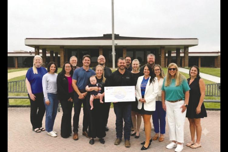 UWEFC Board alongside members of the Impact Seminole Board receiving the $15,000 check officially becoming a Partner Agency.