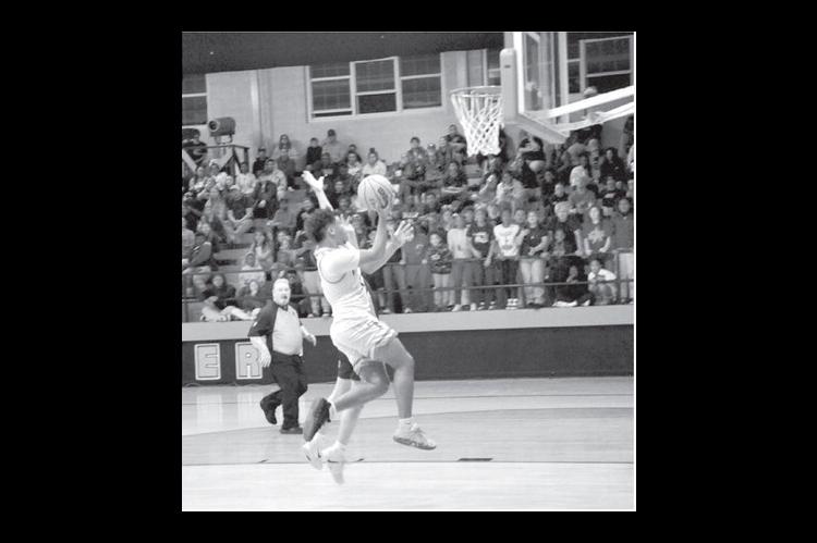 Wewoka Tiger Trae Woods drives in for the basket in last Thursday’s game against the Warner Eagles. Wewoka win the Class 2A, District 4 Championship with a final score of 62-52. (Staff photo by Bill Anderson)