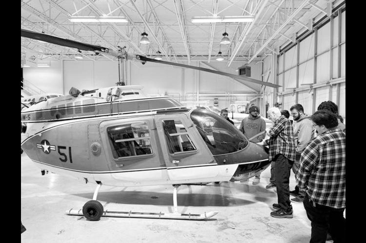 Gordon Cooper Technology Center students and staff observe their new helicopter, acquired through the Oklahoma Federal Surplus program. (Photo provided)