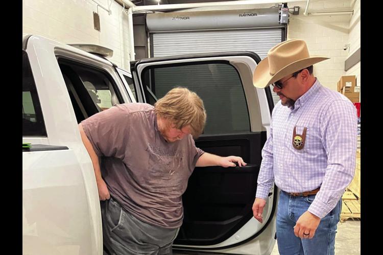 Captain Chris Perteet of the Seminole County Sheriff’s Office unloads Olaf Curtis Green at the Seminole County Jail Thursday, Dec. 19. Green, a resident of Seminole, was booked on charges of transporting a child for purposes of sex trafficking and for violating the Oklahoma Computer Crimes Act. —Photo courtesy Seminole County Sheriff’s Dept.
