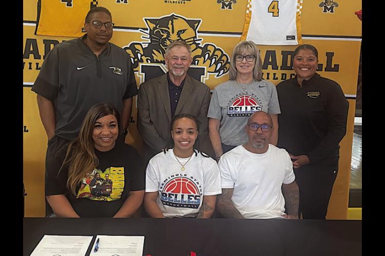 Lamiyah Brown of Madill High School has signed her letter of intent to play basketball for Seminole State. Pictured is Latoyia Brown, Lamiyah Brown, Michael Brown. Standing: Madill coach Carlos Humphrey, SSC Asst. coach Randy Wassam, Head coach Rita Story