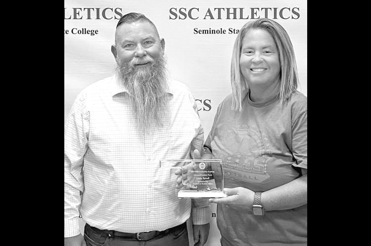 Seminole State College Vice President for Academic and Student Affairs Dr. Bill Knowles (left) presents Athletic Director Leslie Sewell (right) with a plaque recognizing her completion of the Advanced Leadership Track of the 2024-2025 Council on Student A