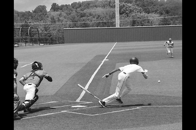 Diamond Dawgs player bunts the ball and races to first base Friday afternoon during Showdown. Staff Photo by Bill Anderson