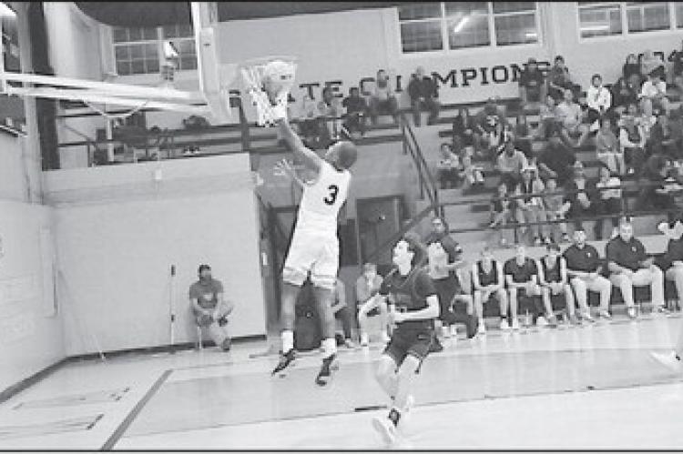 Wewoka Tiger Bill Stephens flies in for the layup Monday night against Vanoss. Wewoka Tigers won 67-60. Staff Photo by Bill Anderson