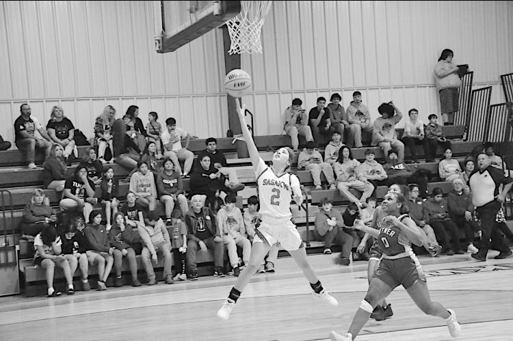 Sasakwa Lady Viking KK Wheeler flies in for the layup just past the Butner Lady Eagle Laniya Walker Friday. Staff Photo by Bill Anderson