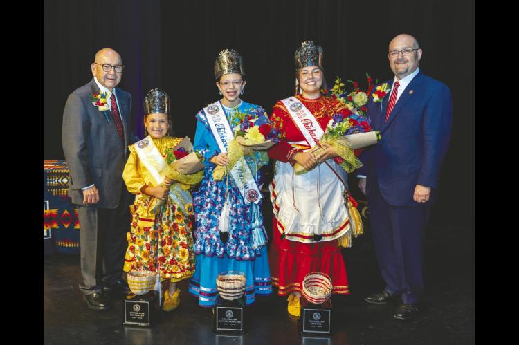 Three talented young ladies were crowned 2025-2026 Chickasaw Princesses during the 2025 Chickasaw Annual Meeting and Festival. From left, Chickasaw Nation Governor Emeritus Bill Anoatubby with Little Miss Chickasaw Paeson Baken, Chickasaw Junior Princess Taylor Komalty, Chickasaw Princess Kaley Reed and Chickasaw Nation Governor Chris Anoatubby. (Photo provided)