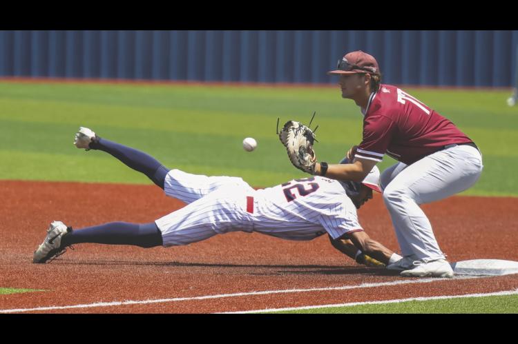 Seminole State Trojan Jaylon Humbles reaches first base on a pick-off throw Thursday. Courtesy Photo by Glen Bryan