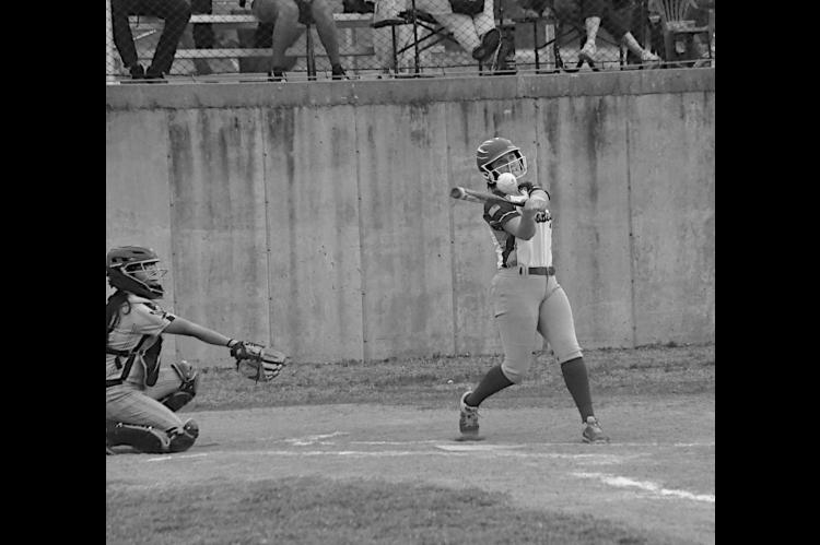 Bowlegs Lady Bison Cira Parsons knocks one to the outfield to get on base. Staff Photo by Bill Anderson