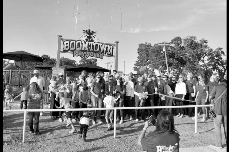 Streamers rise into the air Wednesday evening in celebration of the dedication and official grand opening of Boom Town Playground in the Seminole Municipal Park. The playground was rebuilt with funds from grants and private donations. —Staff Photo by An