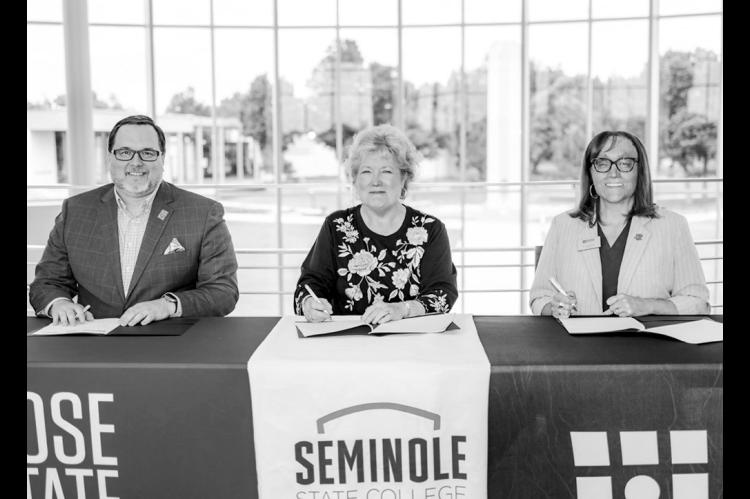 Rose State College President Travis Hurst, Seminole State College President Lana Reynolds and Redlands Community College President Jena Marr sign a memorandum of understanding June 2 at Rose State College. The agreement allows the three institutions to share professional library services beginning July 1, 2026. (Courtesy photo)