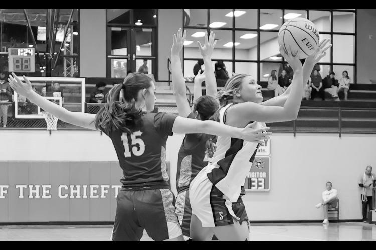 Courtesy Photo by Glen Bryan Seminole Lady Chieftain Jaxie Satawake goes in between two defenders to get a shot at the basket.