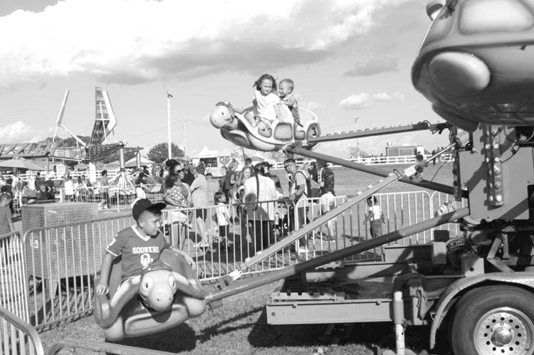 Left, kids enjoy the rides at the 2022 Seminole Nation Days Celebration, held the third week of September at the Mekusukey Mission. There are multiple events scheduled for this week, including a golf tournament, a car show, a parade, live music and a fire