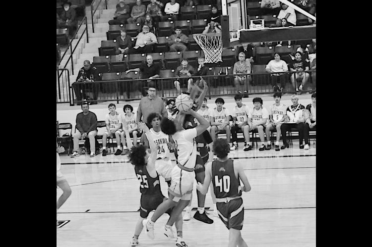 Sasakwa Viking Sherman Mitchell goes in between two defenders for the basket Thursday. Staff Photo by Bill Anderson
