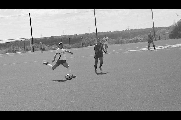 Seminole State Lady Trojan Kayla Pelter shoots for the goal from almost mid-field Sunday afternoon. Staff Photo by Bill Anderson