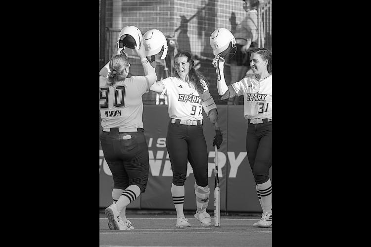 OKC Spark teammates celebrate after a home run was scored Tuesday night.