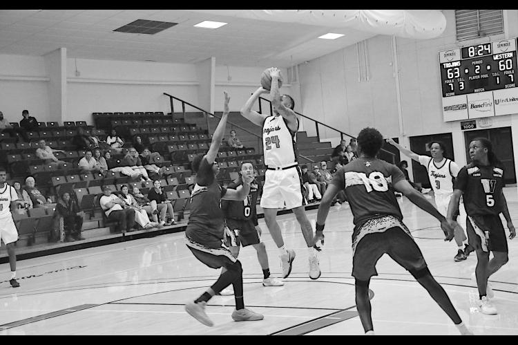 Seminole State Trojan Jamarri Simpson makes the jump shot over the Western Oklahoma State College defender Monday night. Staff Photo by Bill Anderson