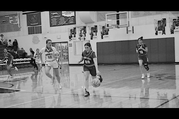 Bowlegs Lady Bison Kasin Kolander drives the ball down field against Macomb defender. Bowlegs lost 27-51. Staff Photo by Bill Anderson