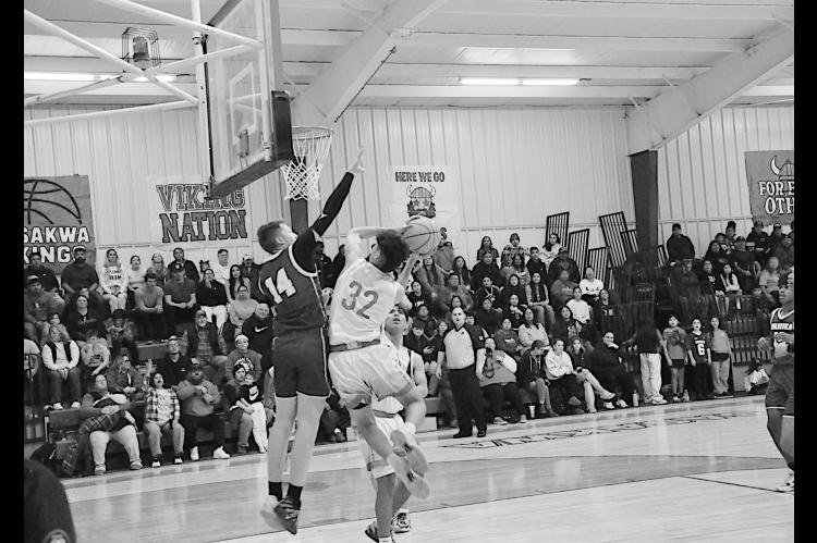 Sasakwa Viking Josh Jones flies in for the shot as the Weleetka defender tries to block Friday night. Sasakwa won 85-35. Staff Photo by Bill Anderson