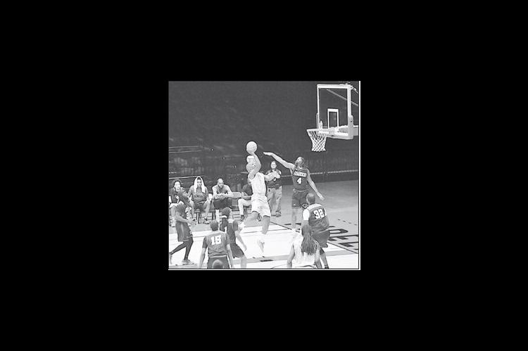 Potawatomi Fire Willie Warren takes the shot over the Outlaw defender Thursday night. Staff Photo by Bill Anderson