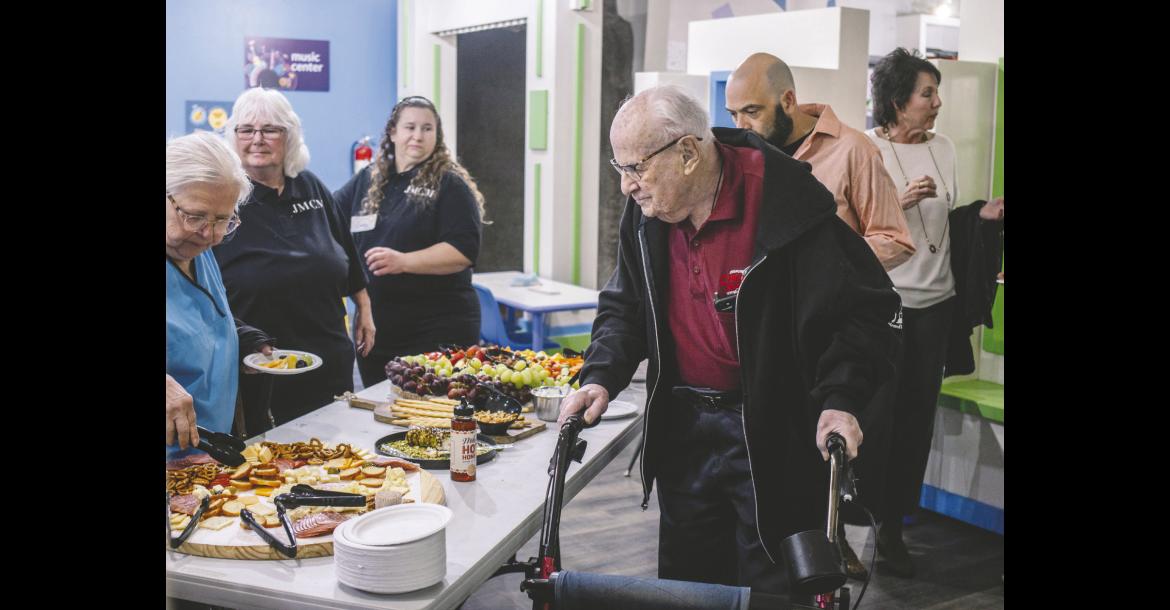 Above, Melvin Moran peruses the food choices at a donor event hosted by the Jasmine Moran Children’s Museum. In August of 1988, Melvin and his wife, Jasmine, visited a children’s museum in Michigan with their daughter and grandchildren. They were so impressed, they decided to build one in Seminole. (Photo by Leslie Werner)