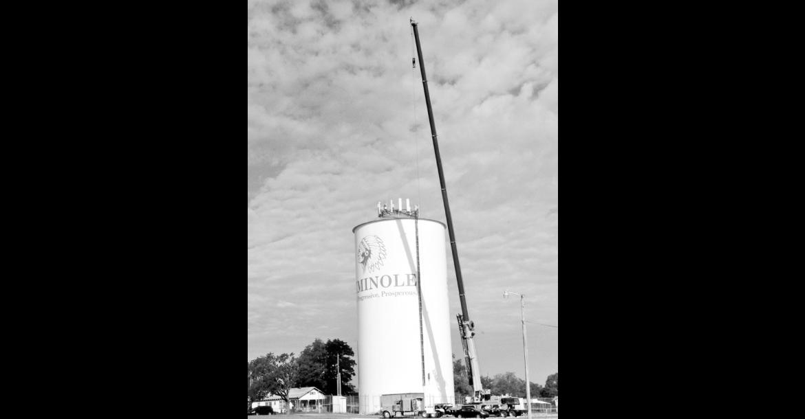 If you spotted a crane hovering over the Highland Street water tower, Cellular One is removing equipment from the top, according to Public Works Director Bryant Baker. —Staff Photo by Bill Anderson