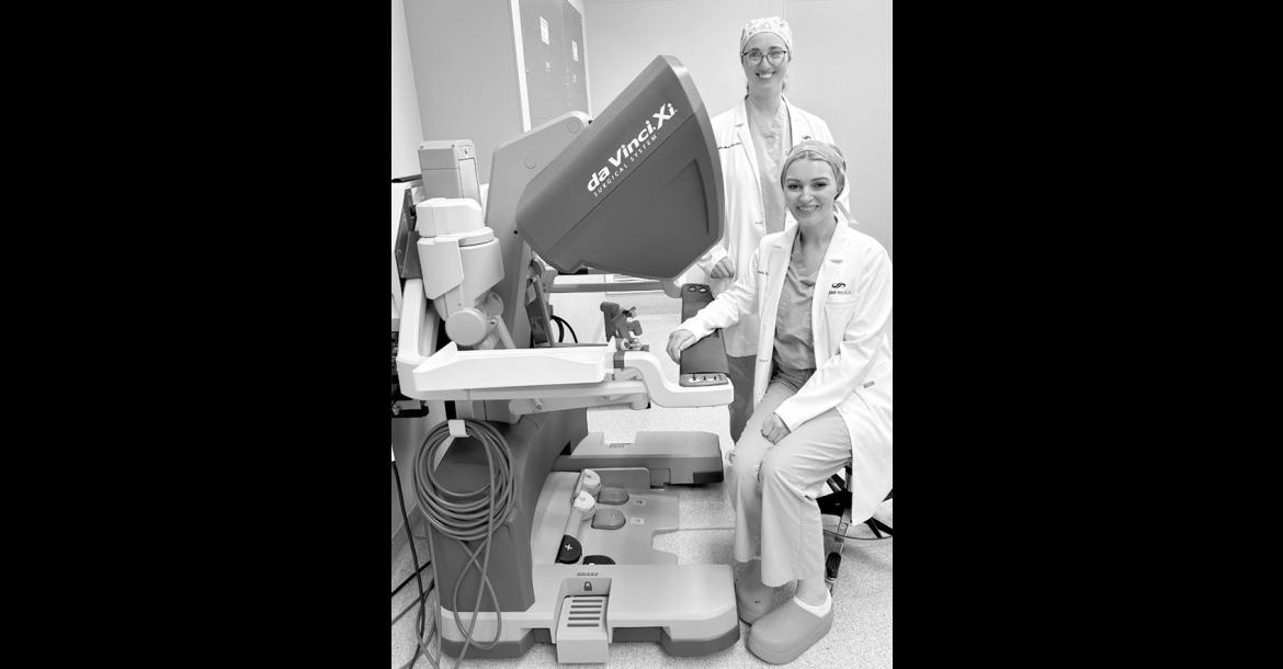 Dr. Amanda Schovanec, seated, and Dr. Danielle Manship at the robot control station at SSM Health St. Anthony Hospital – Shawnee. Surgeons operate the system using a console that translates their hand movements into smaller, highly precise movements of tiny instruments. (Provided)