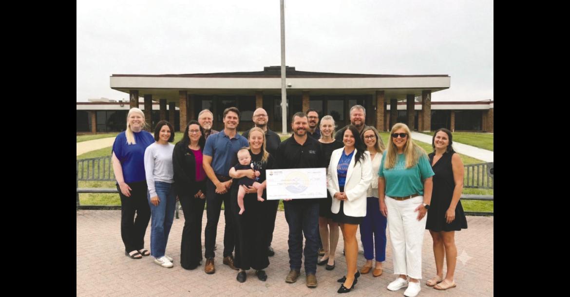 UWEFC Board alongside members of the Impact Seminole Board receiving the $15,000 check officially becoming a Partner Agency.