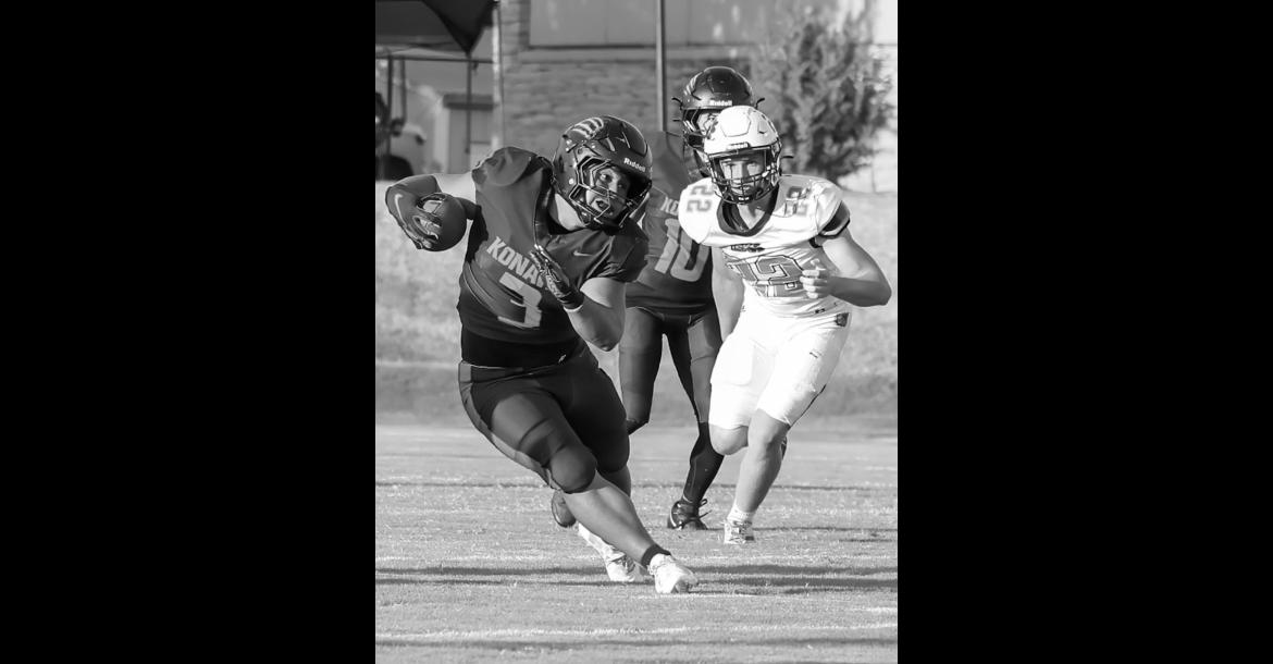 Courtesy Photo by Glen Bryan Konawa Tiger Quentin Shaw finds a running lane through the defense.