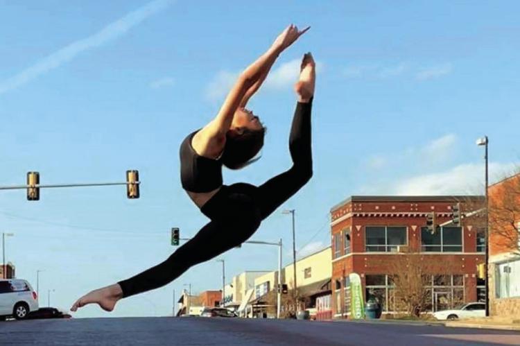 In this file photo from 2021, Alayna Rodriquez leaps across Main Street as a reminder to “spring forward” this weekend. Daylight Saving Time begins at 2 a.m. Sunday, so clocks need to be moved ahead by one hour. —File Photo