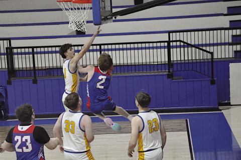 Butner Eagle Rogue Bethany maneuvers around the defender to make the basket. Butner lost 30-60 to Moss. Staff Photo by Bill Anderson