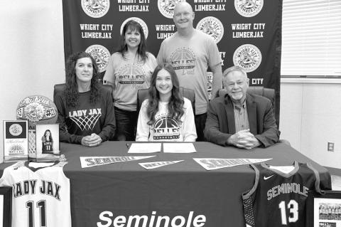 Mia Reich of Wright City High School has signed a letter of intent to play basketball for Seminole State College. Pictured sitting l-r: Wright City basketball coach Misty Haley, Mia Reich and Seminole State Coach Randy Wassam. Standing are Mia’s parents
