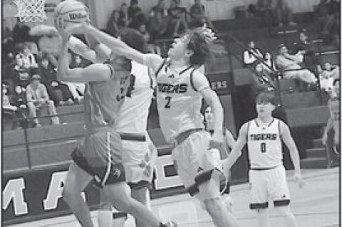 Sasakwa Viking Josh Jones fights off defenders for the basket Tuesday. Staff Photo by Bill Anderson