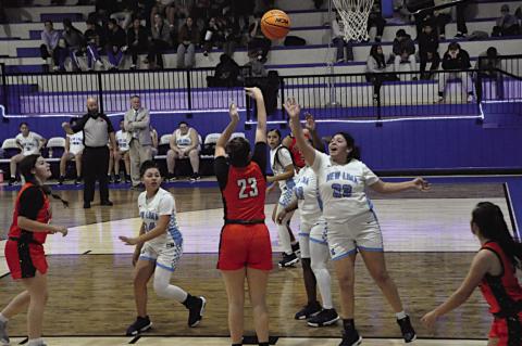 Konawa Lady Tiger Anjli Bahe makes the shot over her defenders Thursday. Staff Photo by Bill Anderson