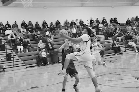 Varnum Whippet Kamell Stewart flies past Pittsburg defenders for the basket Thursday. Staff Photo by Bill Anderson