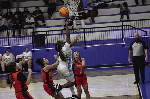New Lima Falconette Aubriana Washington flies in for the basket Thursday. Staff Photo by Bill Anderson