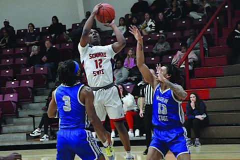 Seminole State Trojan Montae Collins goes up in between two Murray State defenders for the basket. Staff Photo by Bill Anderson