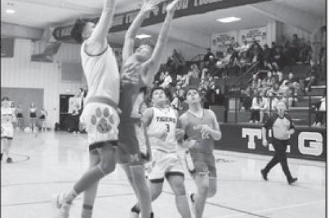 Maud Tiger Treat Marshall goes up and over his defender for the basket. Staff Photo by Andy Wilson