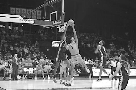 Potawatomi Fire K.T. Bouchum makes the shot despite the defensive pressure. Staff Photo by Andy Wilson