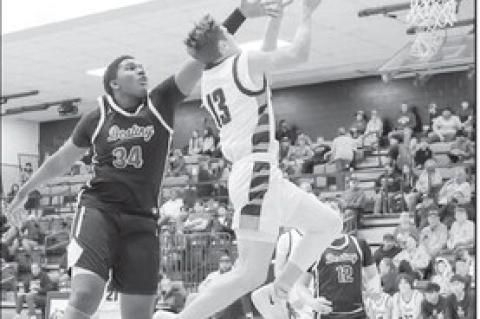 Konawa Tiger Mason Davis drives to the basket for a shot attempt. Courtesy Photo by Glen Bryan