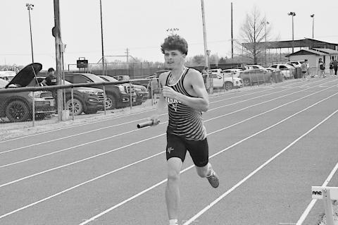 Staff Photo by Bill Anderson Varnum Whippet Ryan Poull drives the last leg of the 4X400 Relay Tuesday