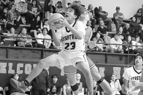 Strother Yellowjacket Payden Madden gets by Konawa Tiger Evan Buxton for a basket attempt Monday Night. Courtesy Photo by Glen Bryan