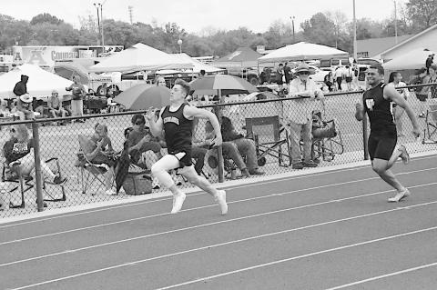 Konawa Tiger Mason Davis sprints to the finish line, followed directly by Wewoka Tiger Mike Piza Friday at Ada. Staff Photo by Bill Anderson