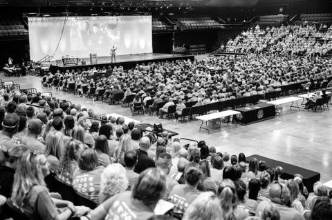 The Avedis Foundation hosted its 8th annual “Celebrate Educators” event on Friday, August 22 at Firelake Arena in Shawnee. Above, Korie Hicks interacts with the “Mirror Man.” Below, keynote speaker Michael Bonner addresses an audience of nearly 2,